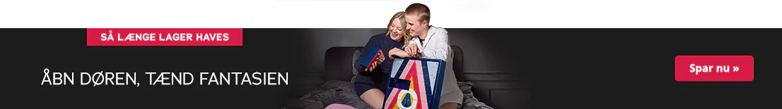 Billedet viser en reklame, hvor to kvinder knæler på en seng og sammen kigger på en lille æske fra julekalenderen. Den er farvestrålende og har påskriften "HOLY NIGHTS". Ved siden af står der med hvid skrift: "Åbn døren, tænd fantasien". Øverst er der en rød knap med teksten "Så længe lager haves".